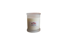 Load image into Gallery viewer, Whiskey Lounge soy candle in a frosted Monaco glass jar beside a glass of whiskey in front of a cosy fireplace β by Rendezvous Candle Co